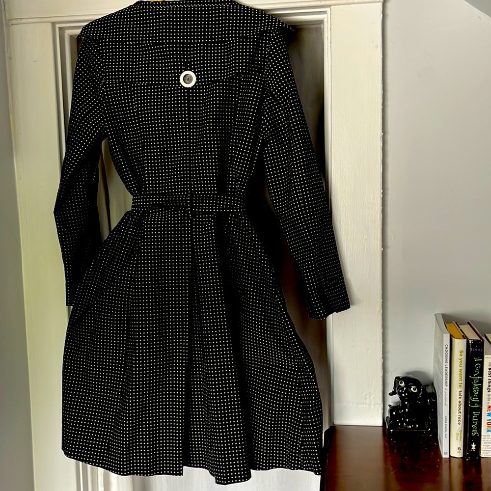 Polka dot rain jacket with 1950’s style with narrow waist and flared skirt.